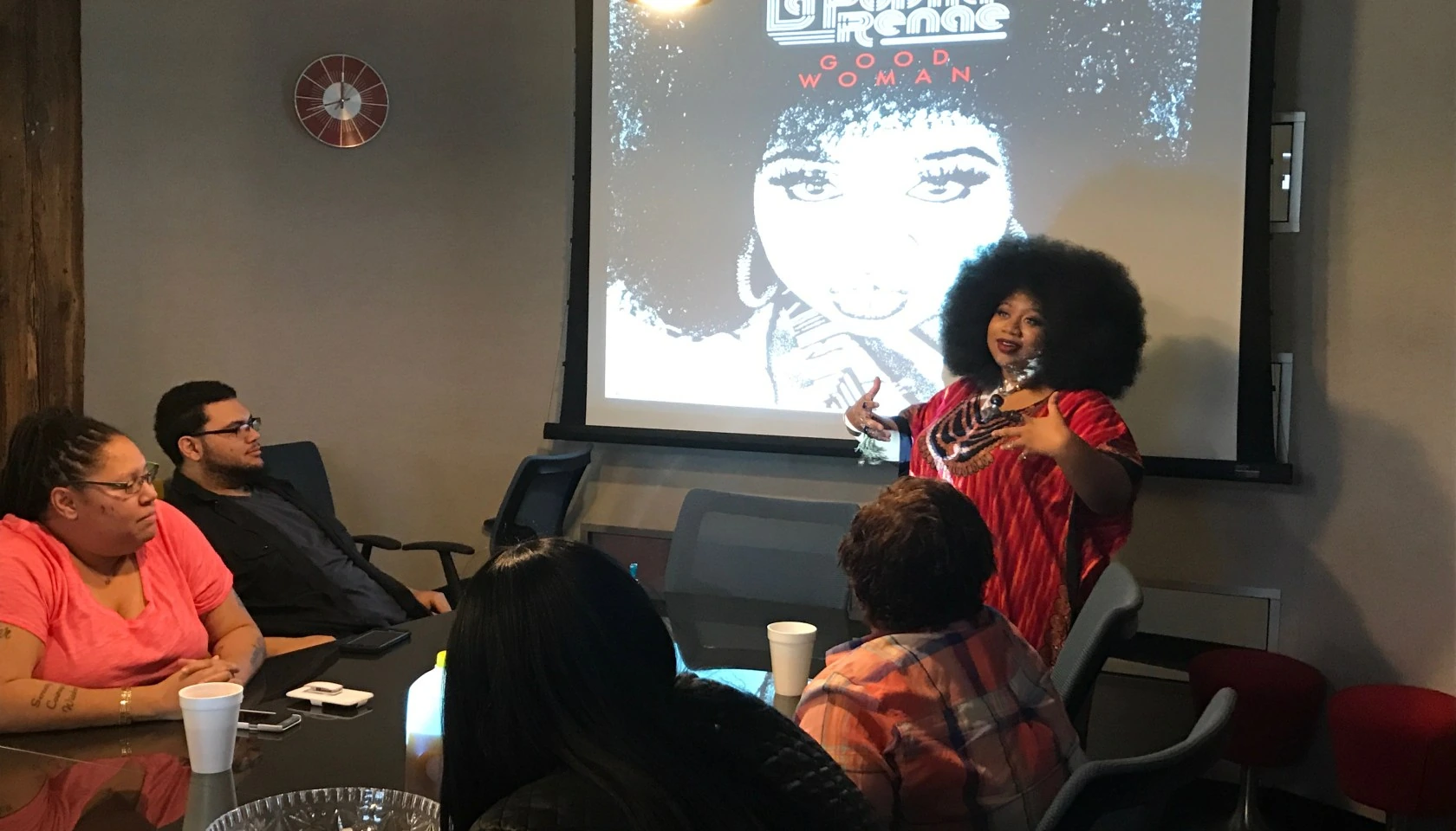 La'Porsha Renae speaking at an event in front of a projected image