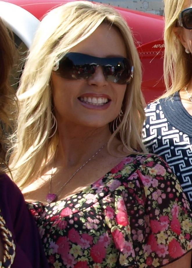 Tamra Judge at a public event wearing sunglasses and a floral top